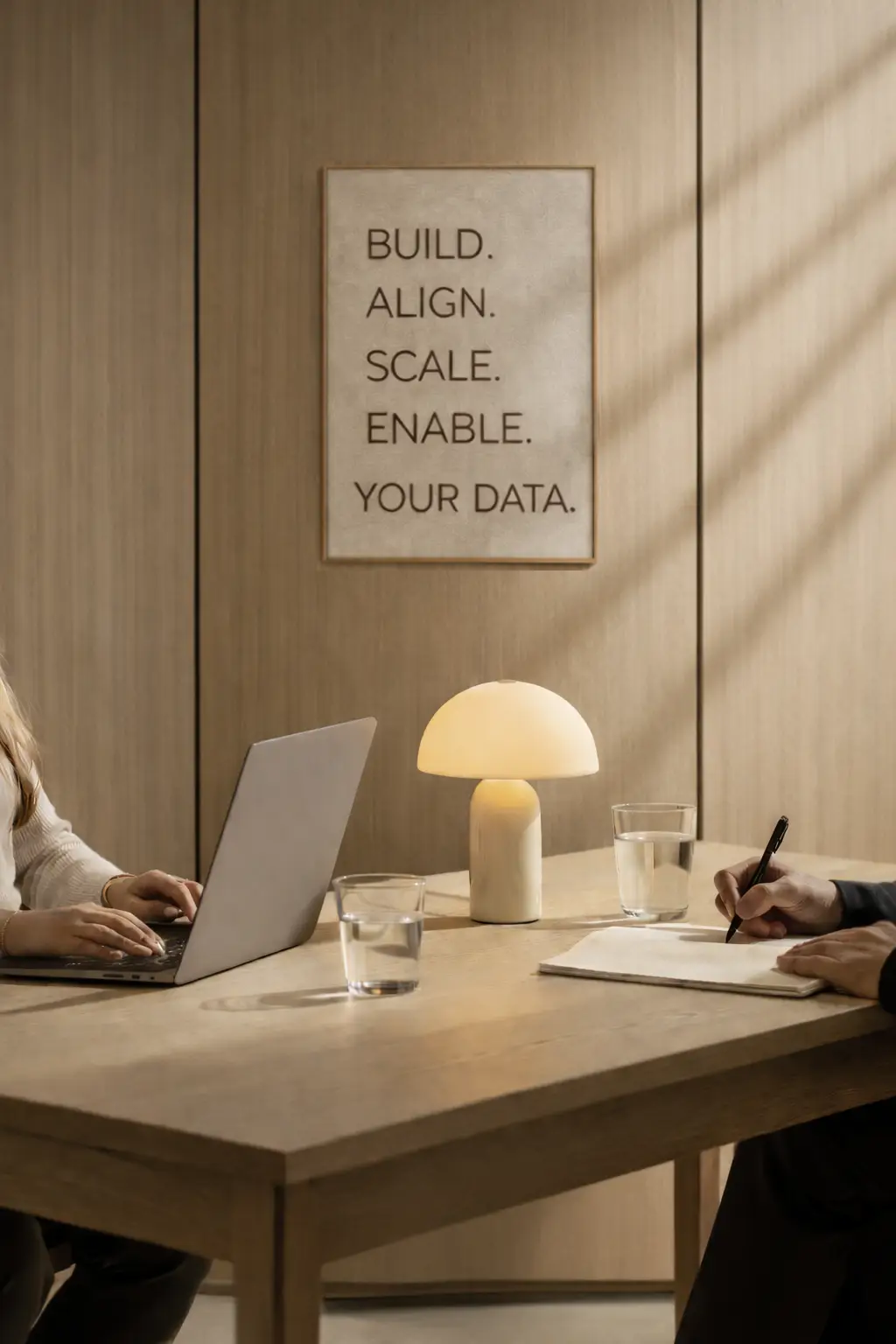 Let's Talk showing two people engaging in one of the service supplied by BASE Data Advisory, including Fractional Head of Data, Data Platform and Strategy, Data Governance, Executive Advisory. With Poster on wall showing BUILD. ALIGN. SCALE. ENABLE. YOUR DATA.